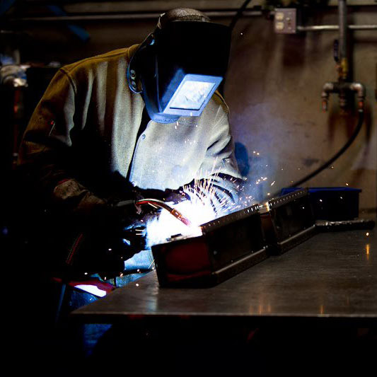 Top heat exchange manufacturer: A JB Radiator Specialties employee welding in the plant.